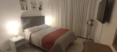 a bedroom with a bed and a table with a lamp at Sumaq Home Lima Airport in Lima