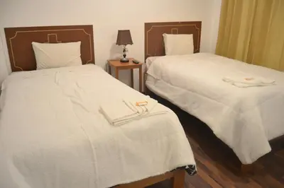two beds sitting next to each other in a room at Apu Wasi in Cusco