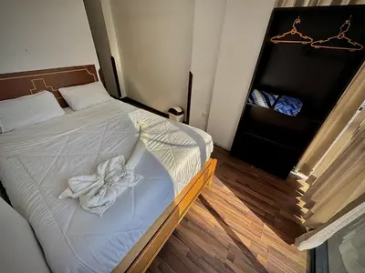 a bedroom with a bed with a flower on it at Apu Wasi in Cusco