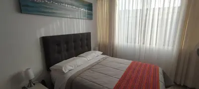 a bedroom with a bed and a window at Sumaq AirPort in Lima