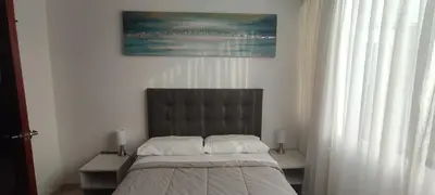 a bedroom with a bed and a painting on the wall at Sumaq AirPort in Lima