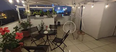 a room with a table and chairs and potted plants at Sumaq AirPort in Lima