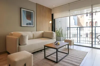 a living room with a couch and a table at One By Wynwood House in Lima