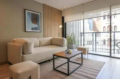 a living room with a couch and a table at One By Wynwood House in Lima