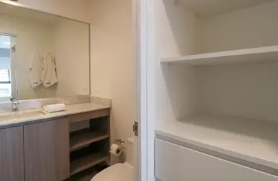 a bathroom with a sink and a toilet and a mirror at One By Wynwood House in Lima