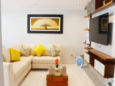 a living room with a couch and a tv at Paloma House in Lima