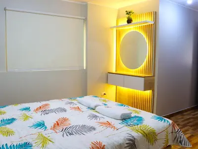 a bedroom with a bed and a mirror at Paloma House in Lima