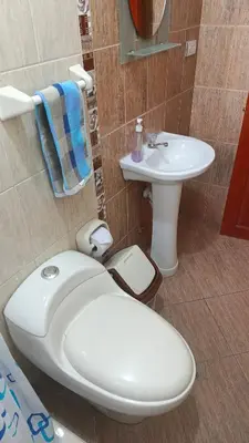 a bathroom with a toilet and a sink at WaskarWasi in Cusco