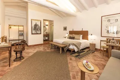 a bedroom with a bed and a living room at Casa Clara by Ananay Hotels in Cusco