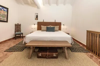 a bedroom with a bed and a wooden table at Casa Clara by Ananay Hotels in Cusco
