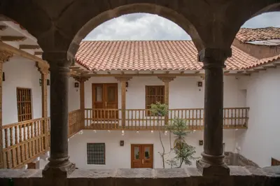 a view of a building through an archway at Casa Clara by Ananay Hotels in Cusco