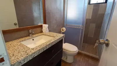 a bathroom with a sink and a toilet and a shower at PACHAMAMA APARTMENt in Urubamba