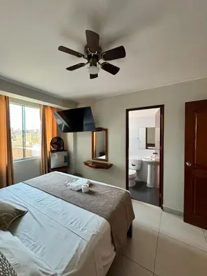 a bedroom with a bed and a ceiling fan at Hotel JOMA in San Vicente de Cañete