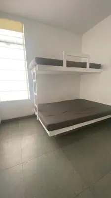 a room with two bunk beds and a window at Casa de Playa frente al mar en Chocalla, Asia in Asia