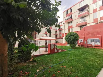 a yard with a gazebo in front of a building at Amplio, y confortable departamento en San Miguel in Lima