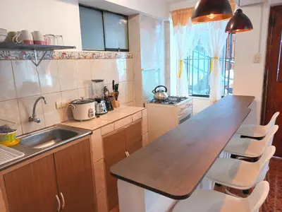 a kitchen with a wooden counter top and a sink at Cuesta del Inka in Cusco