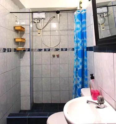 a bathroom with a sink and a shower at Cuesta del Inka in Cusco