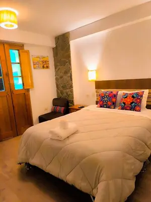 a bedroom with a large bed in a room at hostal Balcon de Piedra in Urubamba