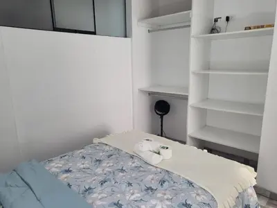 a small bedroom with a bed and a shelf at Miel de Luna in Cerro Azul