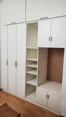a white cabinet with white doors and shelves at CASITA PARA FIN DE SEMANA in Chincha Baja