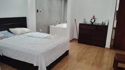a bedroom with a bed and a bath tub at CASITA PARA FIN DE SEMANA in Chincha Baja