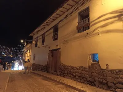 a building on the side of a street at night at Mini Apart II - Sumaq Wasi ALBA in Cusco