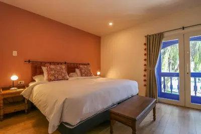 a bedroom with a large bed and a window at Casa Muru By Wynwood House in Cusco
