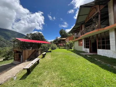 a group of benches in front of a building at Eco Inca Trail Lodge Lucmabamba in Cusco