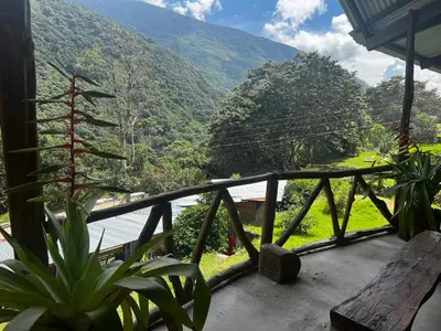a balcony of a house with a view of a mountain at Eco Inca Trail Lodge Lucmabamba in Cusco