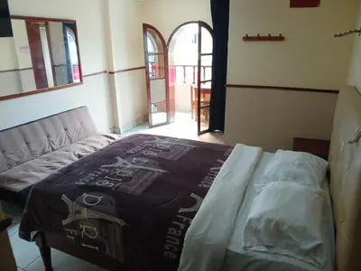 a bed in a room with a bedspread on it at Residencial San Felipe in Lima