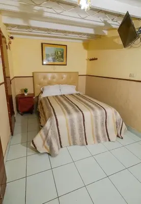 a bedroom with a bed with a blanket on it at Residencial San Felipe in Lima