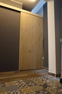 a large wooden door in a room with a rug at Casa sabina hostel in Lima