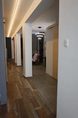 an empty hallway in an office with white walls and wood floors at Casa sabina hostel in Lima