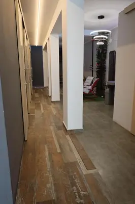 an office hallway with white walls and wooden floors at Casa sabina hostel in Lima