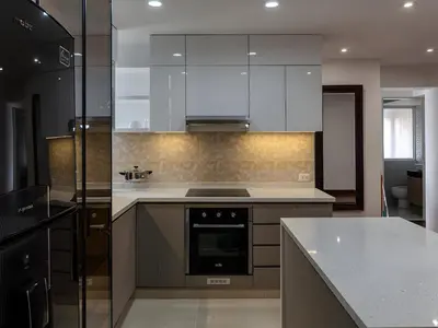 a kitchen with white cabinets and a stove top oven at Acogedor 2BR Center Miraflores - Balta in Lima