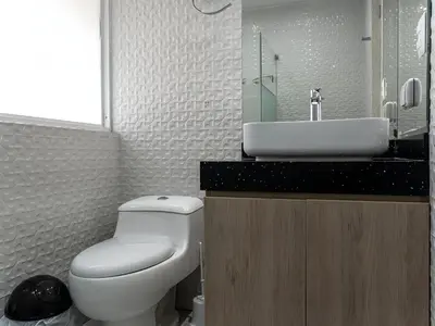 a bathroom with a white toilet and a sink at Acogedor 2BR Center Miraflores - Balta in Lima