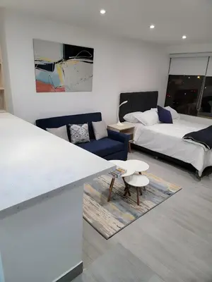 a room with a bed and a couch and a table at Moderno 2BR Center Miraflores- Balta 301 in Lima