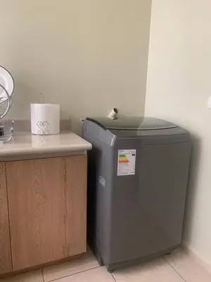 a trash can sitting next to a counter with a table at Apartamento LA ALBORADA para 7 con cochera in Huancayo