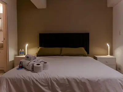 a bedroom with a bed with two rolls of toilet paper on it at Acogedor 2BR Miraflores - Tovar in Lima