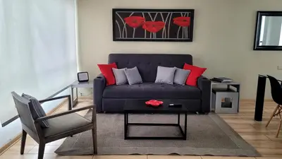 a living room with a couch and a table at Acogedor 2BR Miraflores - Tovar in Lima