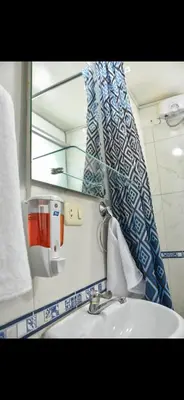 a bathroom with a sink and a mirror at Apu House Minidepartamento in Cusco