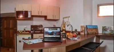 a kitchen with a desk with a laptop on it at Apu House Monoambiente in Cusco