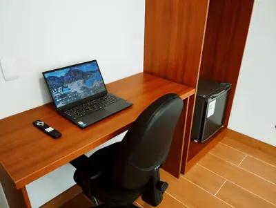 a laptop computer sitting on top of a wooden desk at Casa Pucllana Miraflores - Hotel Boutique in Lima