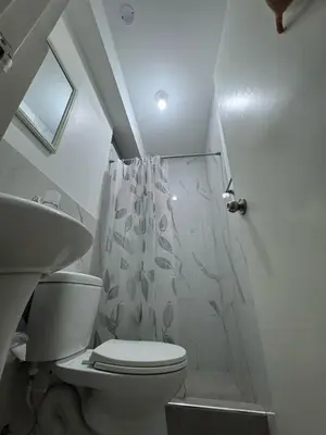 a bathroom with a toilet and a shower at Puerta Azul Hospedaje in Lima