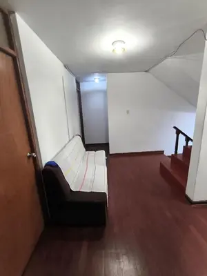 an empty room with a couch and a stair case at Sumaq Wasi Caminos Del Inca in Lima