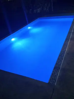 a swimming pool with blue lights on it at Casita de Playa in Barranca