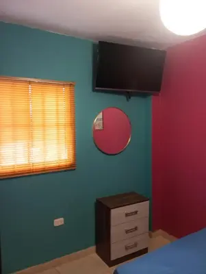 a bedroom with a bed and a mirror on the wall at Casita de Playa in Barranca