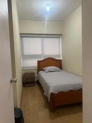 a small bedroom with a bed and a window at Departamento en el edificio más alto del Perú, a 10 min de Plaza de Armas in Lima