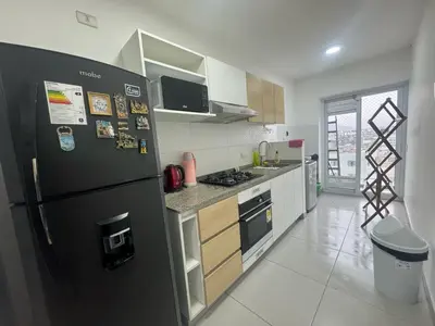 a kitchen with a black refrigerator in a room at Departamento en el edificio más alto del Perú, a 10 min de Plaza de Armas in Lima