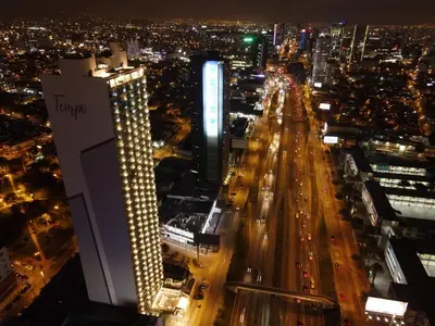 a view of a city at night with traffic at Departamento en el edificio más alto del Perú, a 10 min de Plaza de Armas in Lima